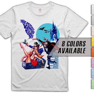 May include: White t-shirt with a retro movie poster design. The graphic features the text "The Fearless Vampire Killers" alongside a scene of vampires and a castle. The shirt also has a colour availability display.