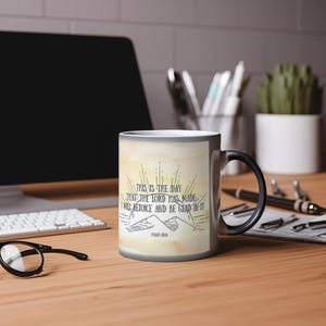 May include: A black and white color changing mug with a watercolor background. The mug features a quote from Psalm 118:24: "This is the day that the Lord has made. I will rejoice and be glad in it."