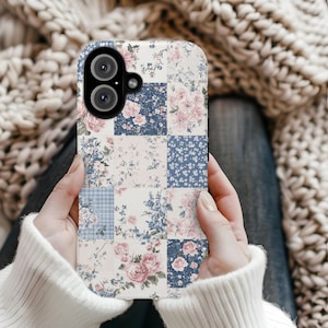 May include: A floral patchwork phone case featuring squares of pink roses, blue floral patterns, and light blue gingham. The case has a black border and a camera cutout.