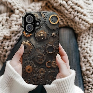 May include: A phone case with a steampunk design featuring intricate gears and cogs in shades of brown, gold, and silver.