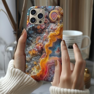 May include: A phone case with a colorful agate pattern. The case features a close-up of the agate's intricate details, showcasing its vibrant orange, red, blue, and yellow hues.