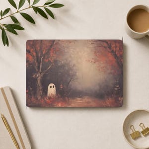 May include: A rectangular print featuring an oil painting of a small white ghost standing in a dark, misty forest with autumn-colored red and orange foliage. The scene depicts a path winding through trees under a soft, hazy light in the background.