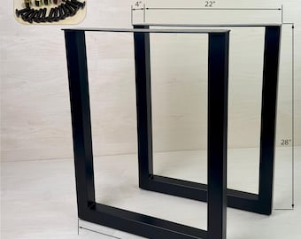 May include: Two black metal table legs with a square shape. The legs are 22 inches wide, 28 inches tall, and 4 inches deep. Screws and nuts are included.