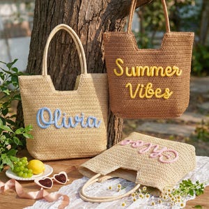 May include: Three woven straw tote bags with two handles each. One light beige bag features the blue text Olivia, one brown bag features the yellow text Summer Vibes, and one light beige bag features the pink text Chloe in cursive script.