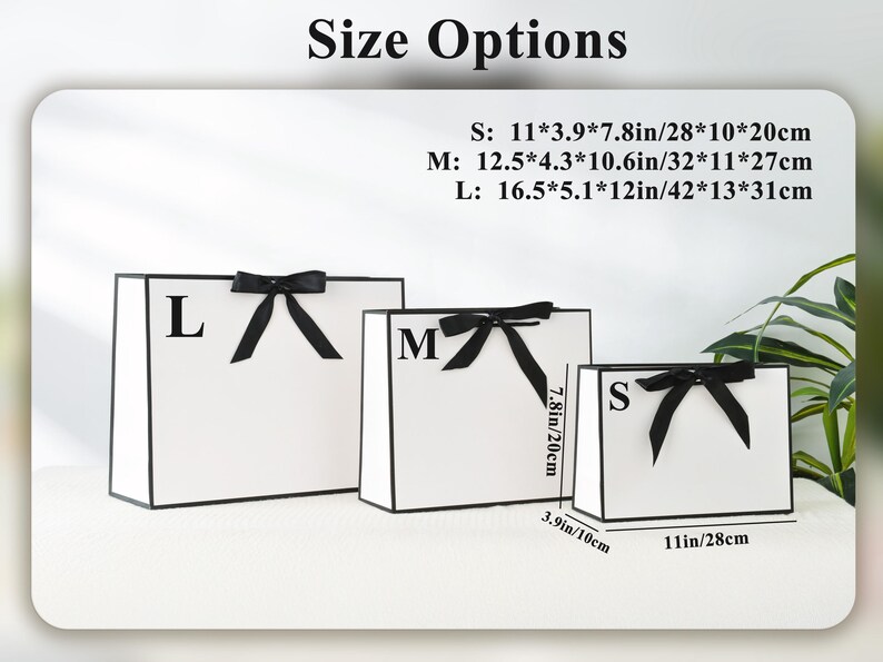 May include: Three white gift bags with black trim and black bows. Sizes are labeled S, M, and L, with dimensions in inches and centimeters. The smallest bag is 11 x 3.9 x 7.8 inches (28 x 10 x 20 cm).