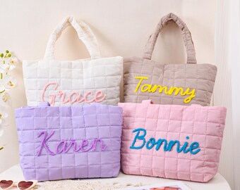 May include: Four quilted tote bags in white, taupe, lavender, and pink. Each bag has a different name embroidered on it: Grace, Tammy, Karen, and Bonnie. The bags have matching handles and a square quilted pattern.