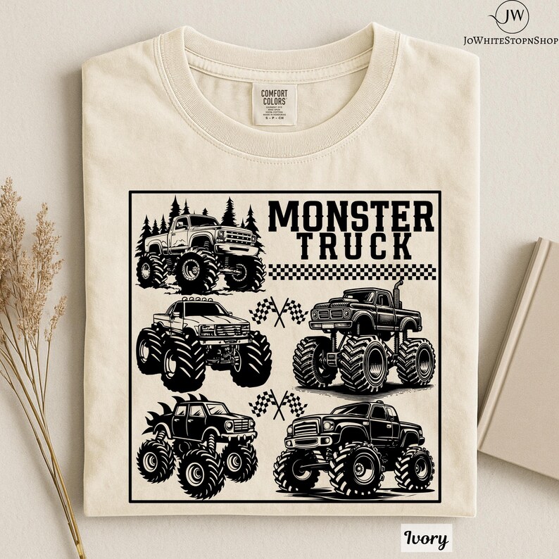 May include: Ivory-colored t-shirt featuring a black and white graphic of several monster trucks. The graphic includes the text "MONSTER TRUCK" and checkered flags. The shirt is made of a soft, comfortable material.