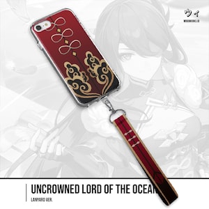 May include: A clear phone case with a red and gold design, featuring a matching lanyard. The case has a decorative pattern with a lanyard attachment. The lanyard is red with white accents. The text "UNCROWNED LORD OF THE OCEAN" is at the bottom.