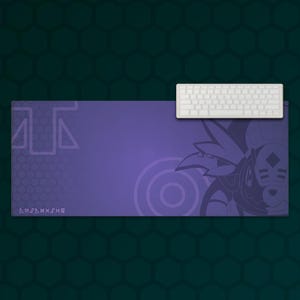May include: A rectangular desk mat in shades of purple featuring a dark purple graphic of a stylised creature on the right side, a geometric pattern on the left, and a white mechanical keyboard positioned on the top right corner of the mat.