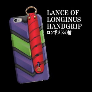 May include: A phone case with a purple, green, and black chevron design. A red leather handgrip is attached with a gold ring. The text "LANCE OF LONGINUS HANDGRIP" and Japanese text are visible.