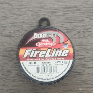 May include: A spool of Berkley FireLine microfused braided bead thread in crystal color. The spool is labeled 4LB, 50YD, and FLBT4-CY. The Beadsmith logo is on the spool.