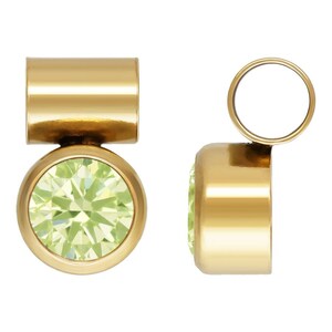 May include: Gold-toned pendant with a round, light green gemstone. The pendant has a cylindrical top and a round bottom.