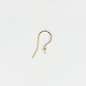 May include: A single gold-colored earring hook, designed for jewelry making. The hook features a curved top, a straight wire for insertion, and a small post with a flat disc for attaching beads or charms. The earring hook is set against a white background.