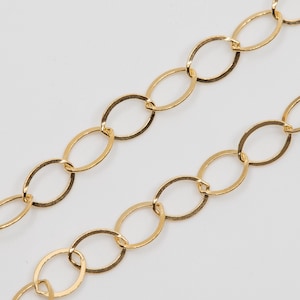 May include: A gold chain necklace with oval links. The chain is made of a smooth, shiny metal.