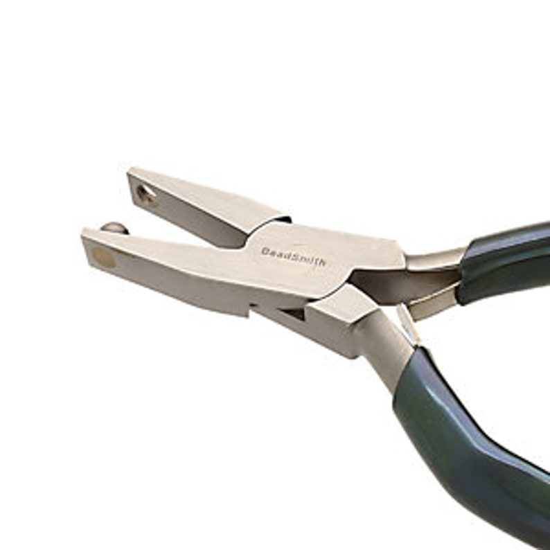 May include: Close-up of a silver bead-tipping pliers with black handles. The pliers are designed for adding beads to the ends of cords or chains.