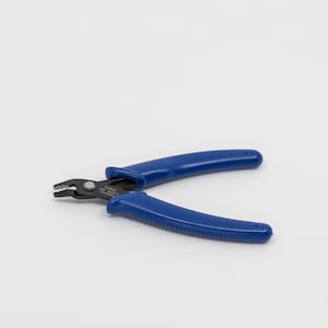 May include: Blue wire cutters with black handles. The handles have a textured grip. The cutters are labeled "Taiwan, High Quality, Glass".