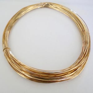 May include: A coil of gold-colored wire, perfect for jewelry making or crafting projects.