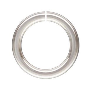 May include: A silver jump ring, a metal ring with a gap, used for jewelry making.