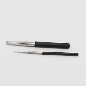 May include: Two retractable metal tools with black handles. The larger tool has five sections and is labeled "BEAR CUTLERY". The smaller tool has three sections and is labeled "BEAR CUTLERY".