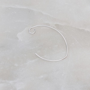 May include: A silver hoop earring with a curved shape and a small loop at the top.