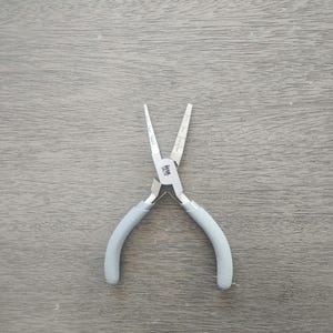 May include: A pair of silver-toned pliers with gray rubberized handles. The pliers have a measurement scale on the side.