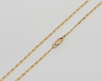 May include: A gold chain necklace with a lobster clasp closure. The chain is made of a delicate, fine-link design.