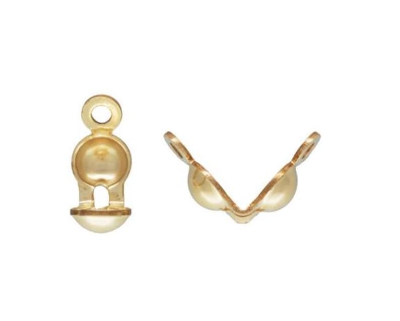May include: Gold-tone metal clasp with a ball-shaped design. The clasp is open and ready to be attached to a necklace or bracelet.