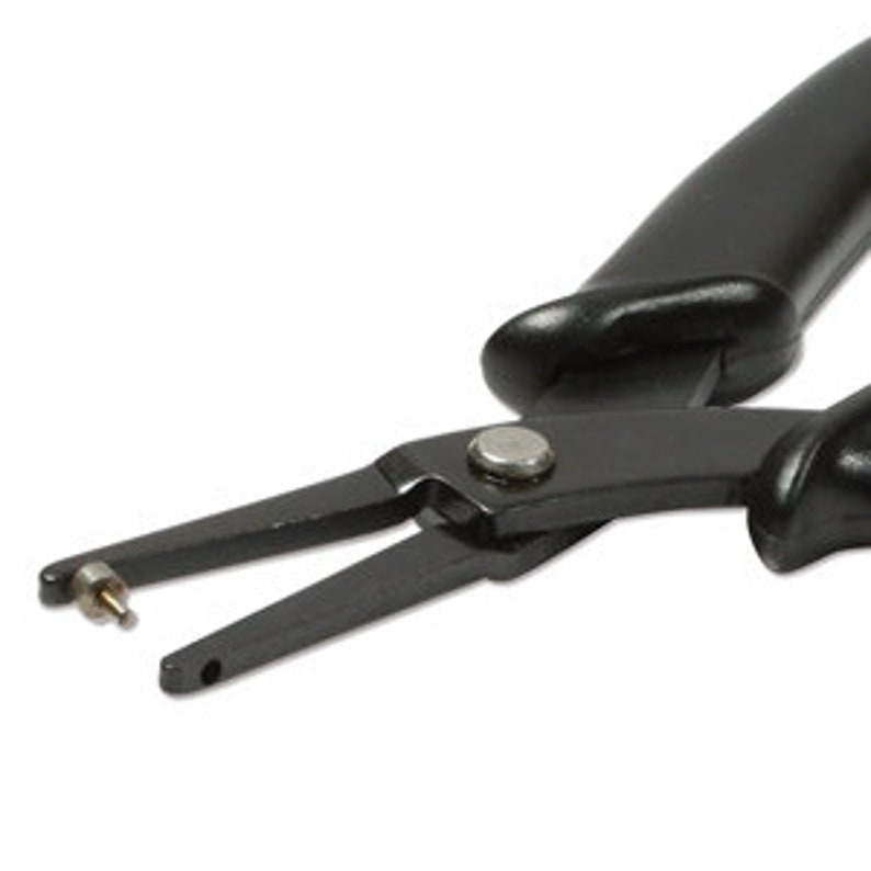 May include: Black metal pliers with a single hole punch. The pliers have a curved handle for grip and a silver rivet. The tool is designed for making holes in various materials.