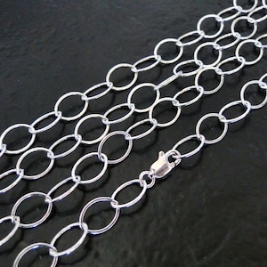 May include: A silver chain necklace with oval links. The chain is made of polished metal and has a lobster claw clasp.