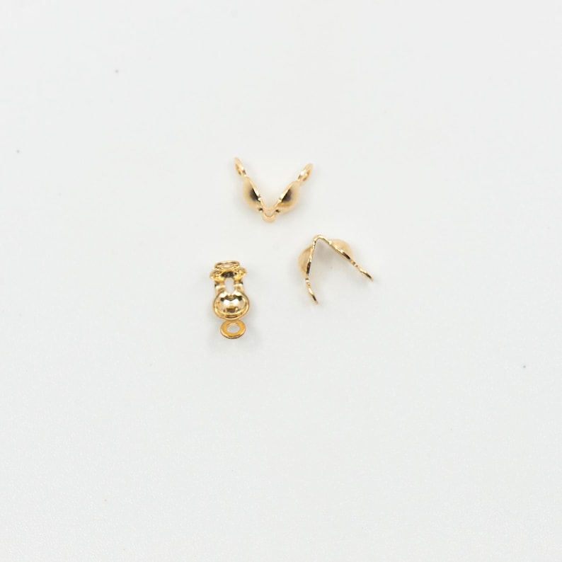May include: Three gold-toned metal clasps for jewelry making. The clasps are designed to be used for necklaces, bracelets, or other jewelry projects.