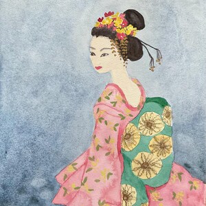 May include: Watercolor painting of a geisha in a pink floral kimono with a green obi. Her hair is styled in a traditional bun, adorned with yellow and red flowers. The background is a soft blue wash.
