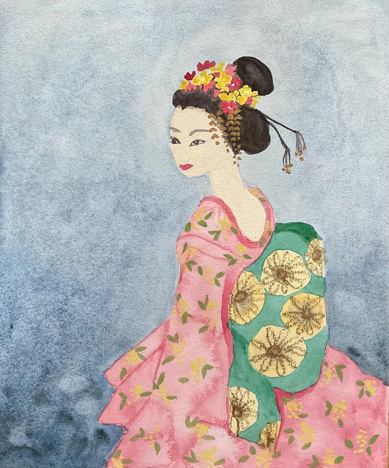 May include: Watercolor painting of a geisha in a pink floral kimono with a green obi. Her hair is styled in a traditional bun, adorned with yellow and red flowers. The background is a soft blue wash.