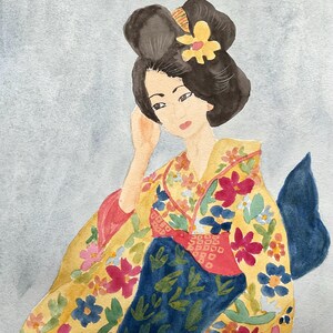 May include: Watercolor painting of a woman in a traditional Japanese kimono. The kimono is yellow with a floral pattern in pink, red, and blue. The woman has dark hair styled in a bun with a yellow flower. The background is a light blue.