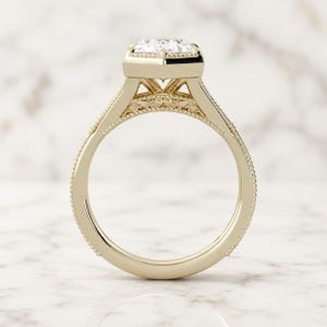 Duchess-cut lab grown diamond engagement ring in 14K yellow gold, side profile showing milgrain bezel, filigree scrollwork and split shank.