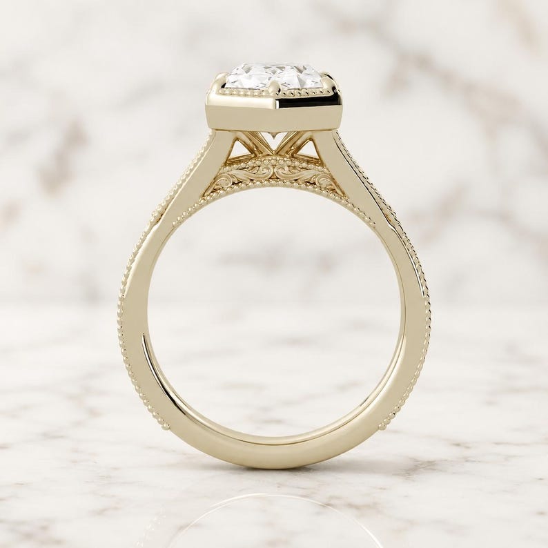 Duchess-cut lab grown diamond engagement ring in 14K yellow gold, side profile showing milgrain bezel, filigree scrollwork and split shank.