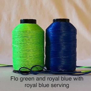 May include: Two spools of thread, one green and one blue. The green spool is labeled "Flo green" and the blue spool is labeled "royal blue".