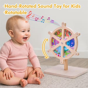 May include: A wooden, hand-rotated sound toy for kids. The toy features a wheel design with colorful panels and small beads. The text "Hand-Rotated Sound Toy for Kids" and "Rotatable" are visible. A baby is smiling next to the toy.
