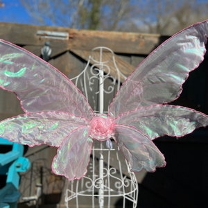 Baby pink wings with darker pink stitching smaller triples