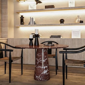 May include: A modern dining room set featuring a round marble table with a red and white pattern, supported by a conical base. The table is surrounded by black chairs with woven seats. Shelves with decorative items are in the background.