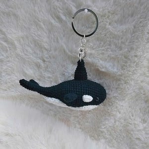 May include: A white ceramic mug with a black handle and the text "But First, Coffee" in a black, handwritten-style font. The mug is on a white surface.