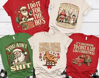 May include: Five short-sleeved t-shirts with Christmas-themed graphics. The red shirt features Santa in a chimney with text "I DO IT FOR THE HO'S". The cream shirt shows holiday characters with "WE WISH YOU NOTHING BUTT MERRY CHRISTMAS". The green shirt depicts Santa with "YOU AIN'T GETTING SHIT". The cream shirt shows a gingerbread man with "POUR SOME SUGAR ON ME". The red shirt features a truck with "IT'S BEGINNING TO COST A LOT LIKE CHRISTMAS".
