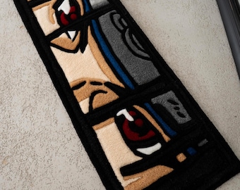 May include: A rectangular rug featuring a stylized anime-style face with red eyes, beige skin, and brown hair. The design is segmented into three rectangular panels with a thick black border. The rug is made of a soft, textured material.