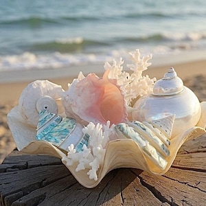 May include: A white ceramic mug with a black handle and the text "But First, Coffee" in a black, bold font. The mug is on a white surface. The mug is approximately 4 inches tall.