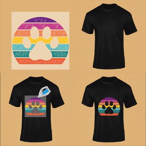 May include: A black t-shirt with a rainbow paw print design. The design is a circle with a paw print in the center and rainbow stripes around the outside. The design is on a black t-shirt.