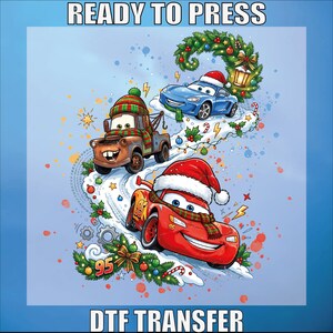 May include: A DTF transfer sheet featuring the text READY TO PRESS and DTF TRANSFER. The graphic shows three cartoon cars, including a red race car with number 95, a brown tow truck, and a blue car, all wearing Santa hats and scarves.