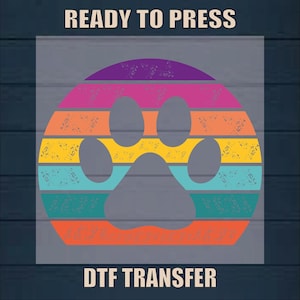 May include: A rainbow-colored paw print design with a distressed vintage look. The design is ready to be pressed onto a t-shirt using a DTF transfer.