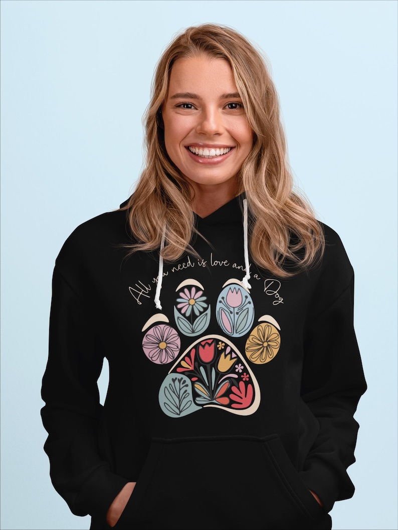 May include: Black hoodie with a floral paw print design and the text "All you need is love and a Dog".