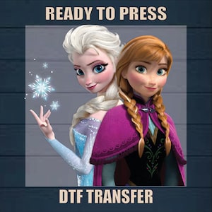 May include: Ready to Press DTF Transfer featuring a colorful image of Elsa and Anna from the movie Frozen. The image shows Elsa with her signature ice powers and Anna in her purple cape.