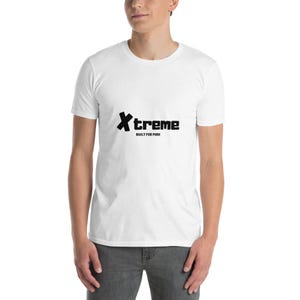 May include: White t-shirt featuring the word "Xtreme" in black, bold lettering. Beneath it, the text "BUILT FOR PARK" is printed in smaller black letters. The t-shirt has short sleeves.