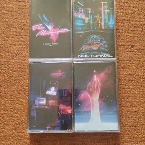 May include: Four cassette tapes with different album covers. The first tape has a pink and blue graphic with the text "The Midnight - A Endless Summer". The second tape has a city scene at night with the text "Nocturnal". The third tape has a computer screen with the text "Monsters" and the fourth tape has a hand reaching up from a blue and pink galaxy.